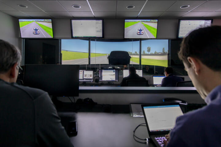 Test engineers follow the simulations on several monitors.